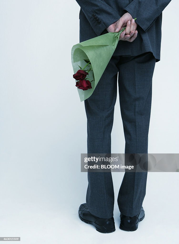 Man Holding Flowers Behind His Back