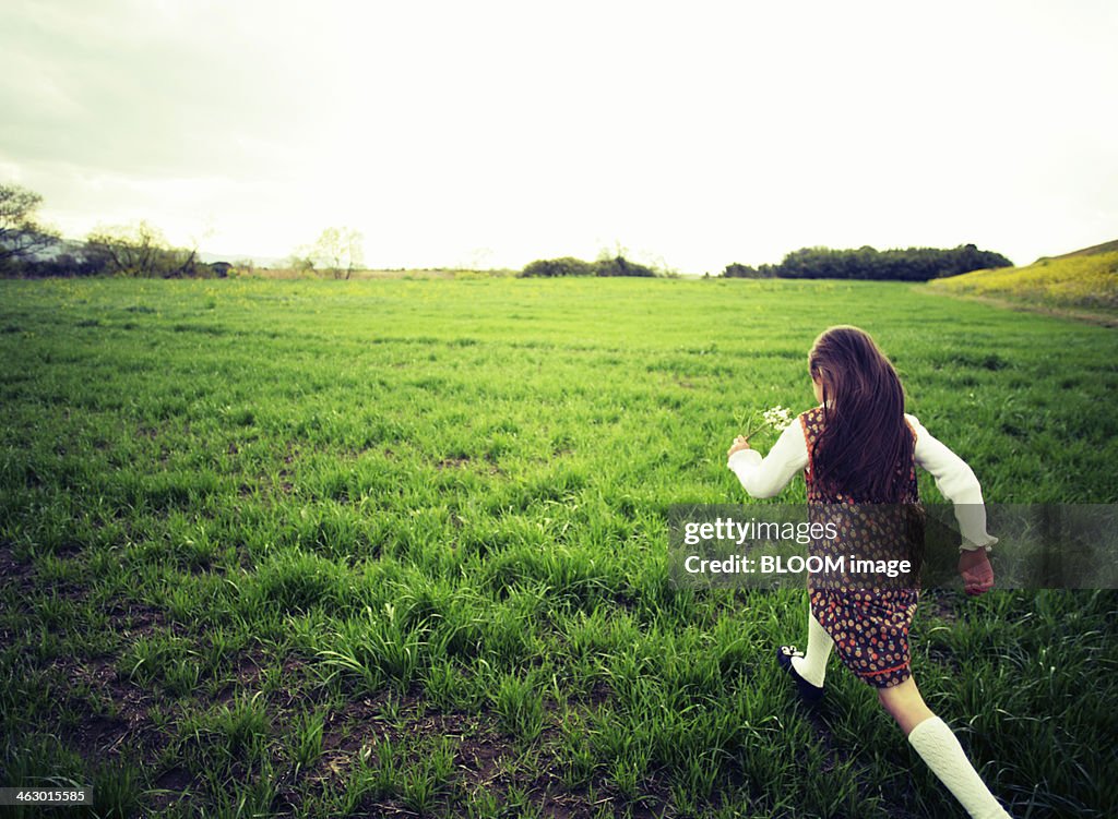 Girl Running Over Green Grass