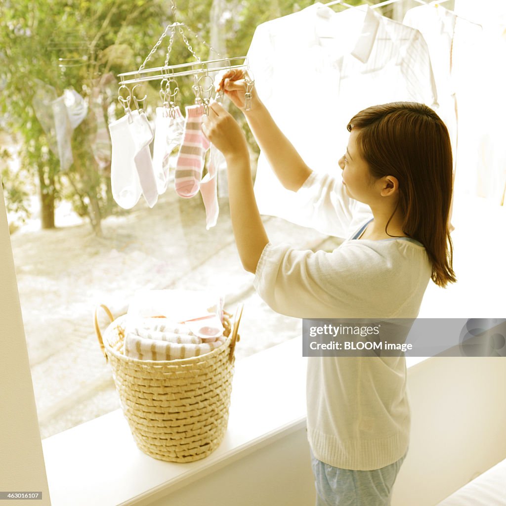 Young Woman Drying Clothes