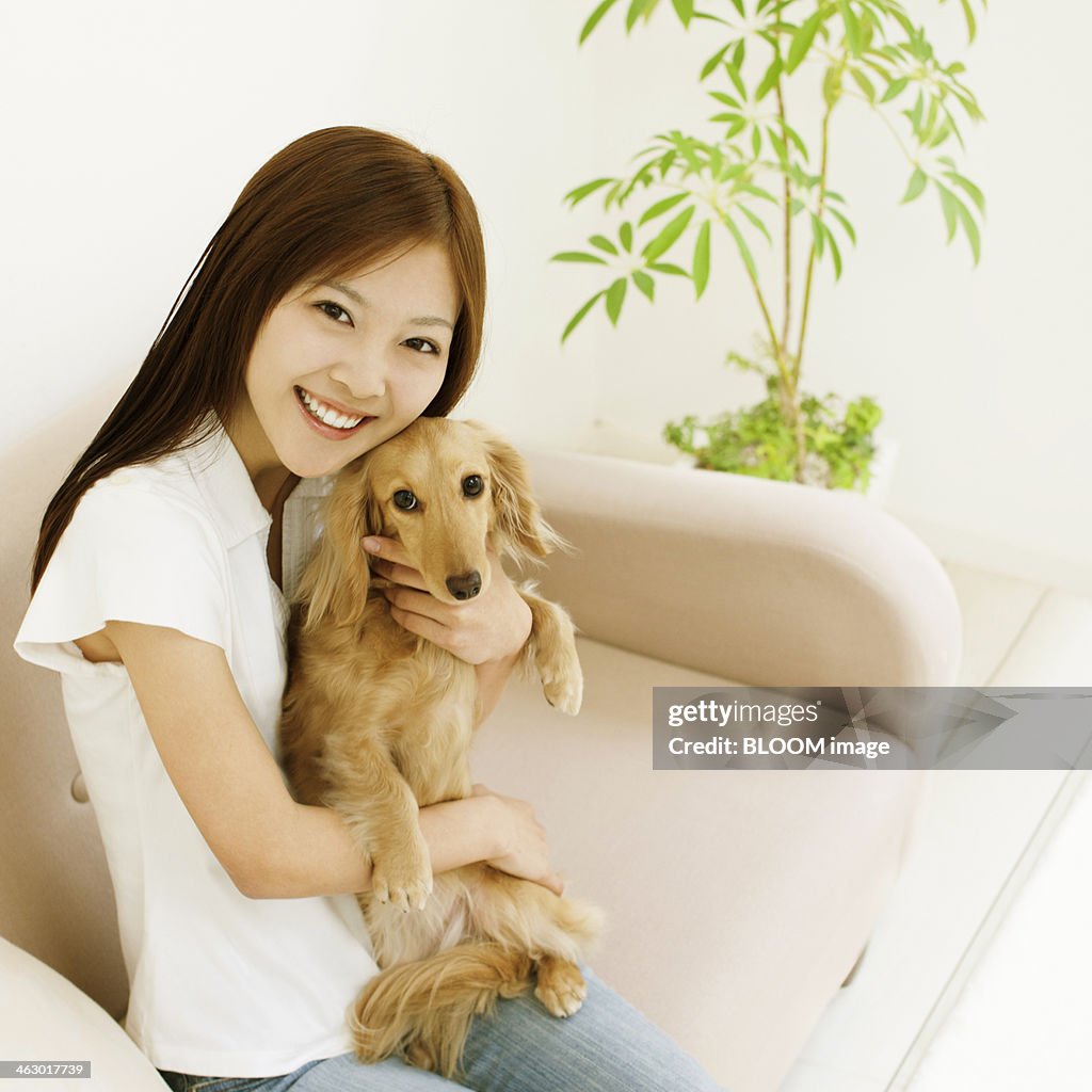 Woman Holding Miniature Dachshund