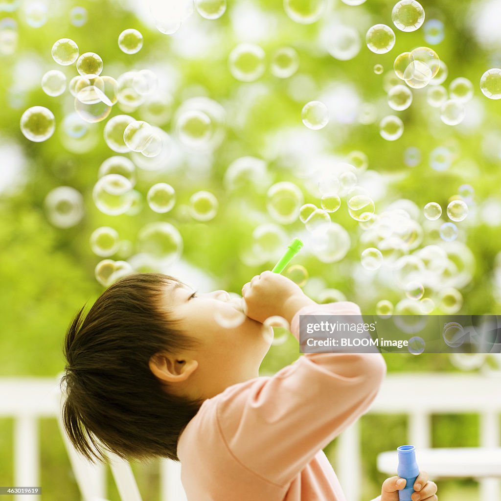 Boy Blowing Soap Bubbles