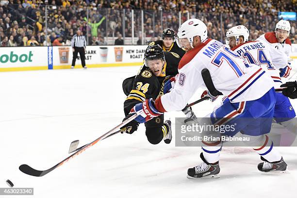 Carl Soderberg of the Boston Bruins fights for the puck against Andrei Markov of the Montreal Canadiens at the TD Garden on February 8, 2015 in...