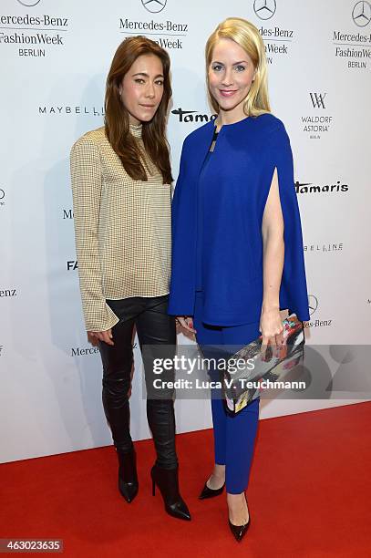 Judith Rakers and Angela Gessmann attend the Laurel show during Mercedes-Benz Fashion Week Autumn/Winter 2014/15 at Brandenburg Gate on January 16,...