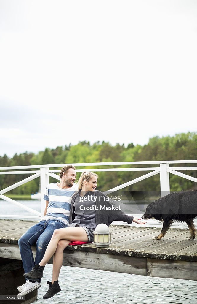 Couple with dog on pier