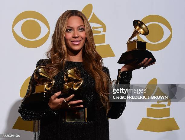 Beyonce poses with her three Grammys in the press room during the 57th annual Grammy Awards in Los Angeles, California on February 8, 2015. Beyonce...