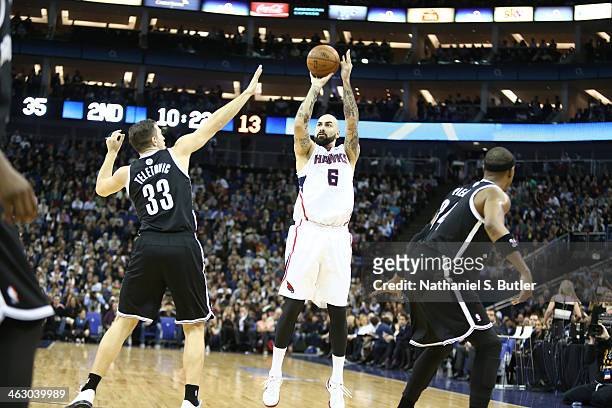 Pero Antic of the Atlanta Hawks shoots against Mirza Teletovic of the Brooklyn Nets as part of the 2014 Global Games on January 16, 2014 at The O2...