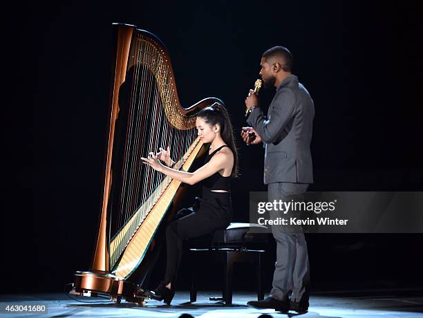 Musician Melody Tai and recording artist Usher perform onstage during The 57th Annual GRAMMY Awards at the STAPLES Center on February 8, 2015 in Los...