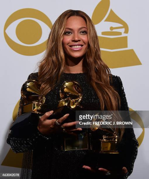 Beyonce poses with her three Grammys in the press room during the 57th annual Grammy Awards in Los Angeles, California on February 8, 2015. Beyonce...