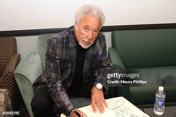 Singer Tom Jones poses backstage at the GRAMMY Charities Signings during The 57th Annual GRAMMY Awards at the STAPLES Center on February 8, 2015 in...