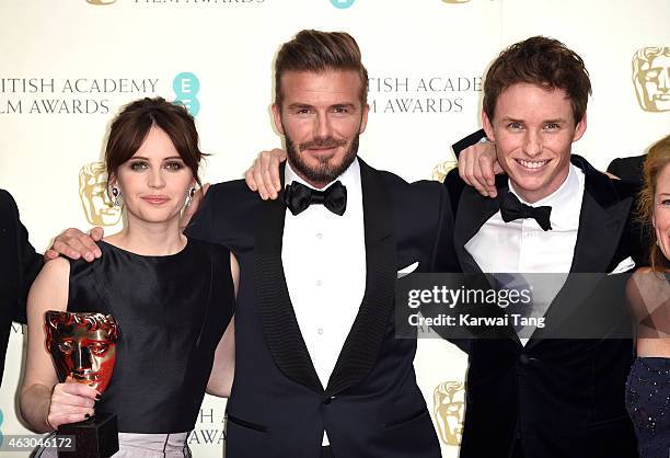 Presenter David Beckham poses with Felicity Jones and Eddie Redmayne with the Outstanding British Film award for 'The Theory Of Everything' in the...