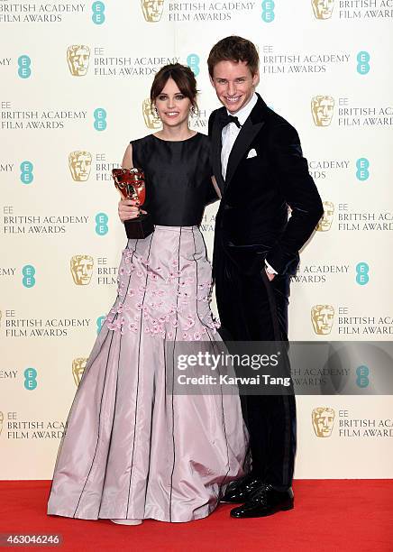 Felicity Jones and Eddie Redmayne pose with the Outstanding British Film award for 'The Theory of Everything' in the winners room at the EE British...