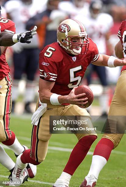 Jeff Garcia of the San Francisco 49ers scrambles away from the pressure against the Chicago Bears during an NFL Football game September 7, 2003 at...