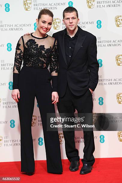 Noomi Rapace and Jesse Eisenberg pose in the winners room at the EE British Academy Film Awards at The Royal Opera House on February 8, 2015 in...