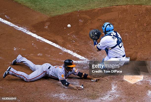 Jose Molina of the Tampa Bay Rays tags out Alexi Casilla of the Baltimore Orioles at home plate during the game on Monday, September 23, 2013 at...