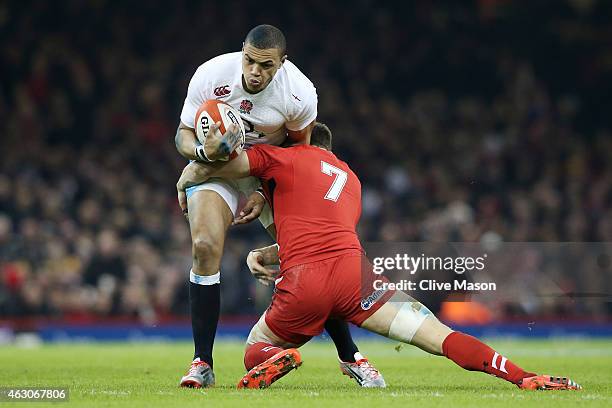 Luther Burrell of England is tackled by Sam Warburton of Wales during the RBS Six Nations match between Wales and England at the Millennium Stadium...