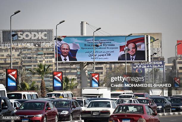 Banner displaying the portrait of Russian President Vladimir Putin and his Egyptian counterpart Abdel Fattah al-Sisi, is seen erected on a Cairo's...