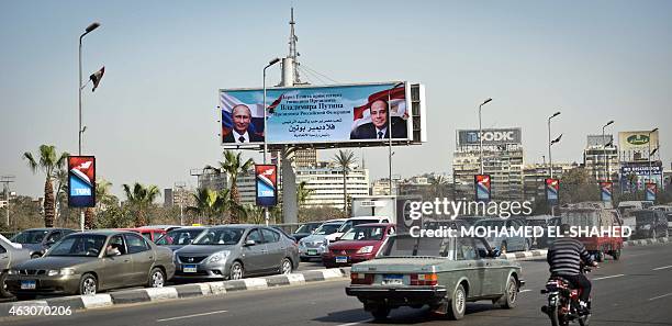 Banner displaying the portrait of Russian President Vladimir Putin and his Egyptian counterpart Abdel Fattah al-Sisi, is seen erected on a Cairo's...