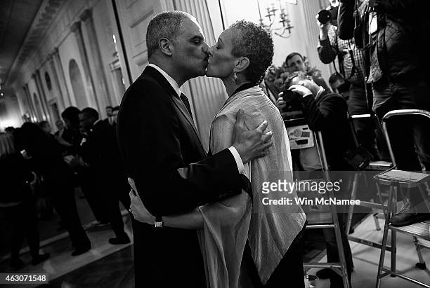 Attorney General Eric Holder kisses his wife, Sharon Malone , after announcing his resignation at the White House September 25, 2014 in Washington,...
