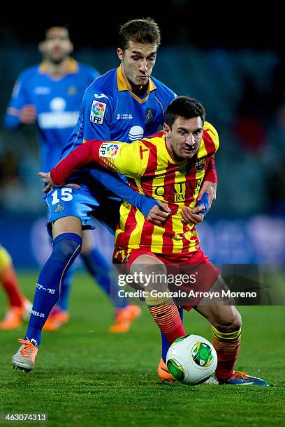 Lionel Messi of FC Barcelona competes for the ball with Rafael Lopez of Getafe CF during the Copa del Rey Round of 8 second leg match between Getafe...