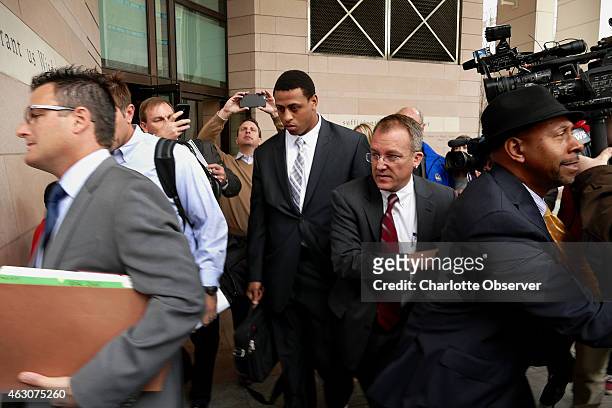 Carolina Panthers defensive end Greg Hardy and his attorney Chris Fialko exit the Mecklenburg County Courthouse as media members seek comment on Feb....