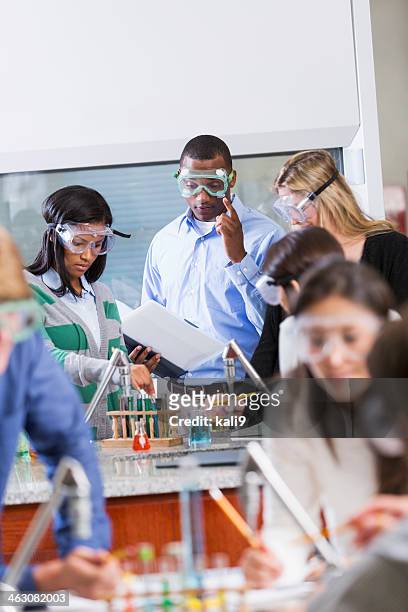 teacher with group of students in chemistry class - science teacher stock pictures, royalty-free photos & images