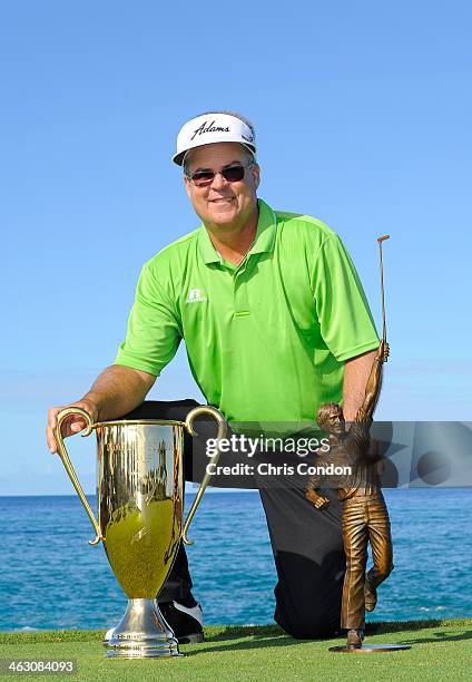 Kenny Perry poses with the Jack Nicklaus Award and the Charles Schwab Cup during the Thursday Pro Am at the Mitsubishi Electric Championship at...