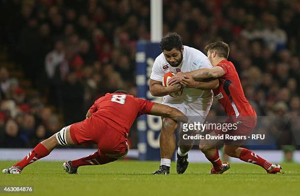 Billy Vunipola of England is tackled by Toby Faletau of Wales and Rhys Webb of Wales during the RBS Six Nations match between Wales and England at...