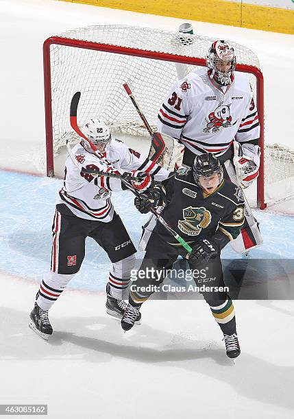 Aleksander Mikulovich of the Niagara IceDogs battles against Julius Bergman of the London Knights during an OHL game at Budweiser Gardens on February...