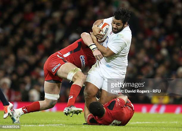 Billy Vunipola of England is tackled by Dan Lydiate of Wales and Toby Faletau of Wales during the RBS Six Nations match between Wales and England at...