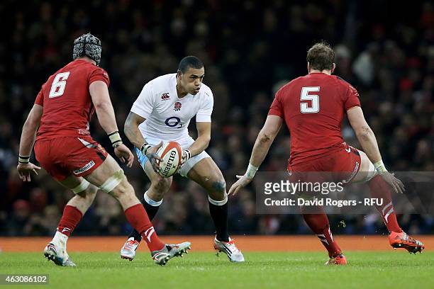 Luther Burrell of England is challenged by Dan Lydiate of Wales and Alun Wyn Jones of Wales during the RBS Six Nations match between Wales and...