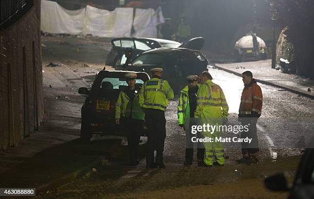 Police continue their investigations at the scene of a fatal road traffic collision involving a lorry and a number of cars on February 9, 2015 in...