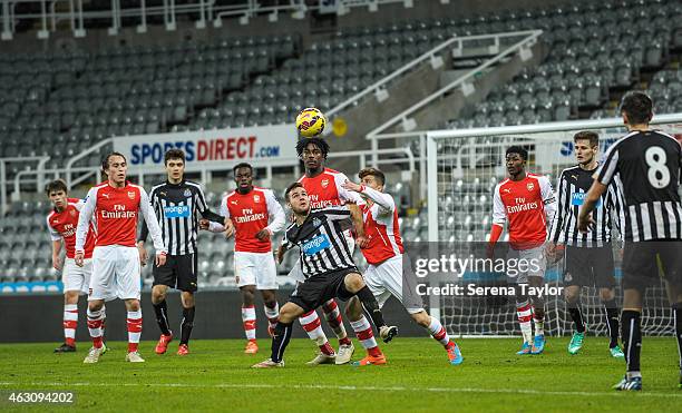 Adam Armstrong of Newcastle is challenged by George Dobson and Stefan O'Connor of Arsenal during the U21 Barclays Premier League match between...