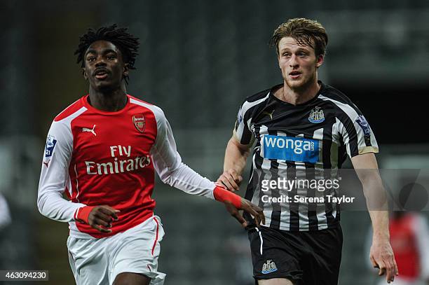 Tom Heardman of Newcastle runs along side Stefan O'Connor of Arsenal during the U21 Barclays Premier League match between Newcastle United and...