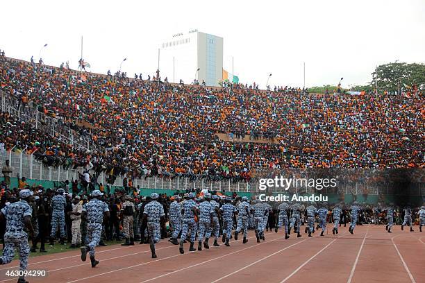 Security officials tighten security measures as Ivory Coast's national football team players tour the Municipal stadium during a welcoming ceremony...