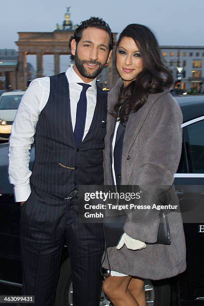 Rebecca Mir and Massimo Sinato arrive at the Marc Cain show during Mercedes-Benz Fashion Week Autumn/Winter 2014/15 at Brandenburg Gate on January...