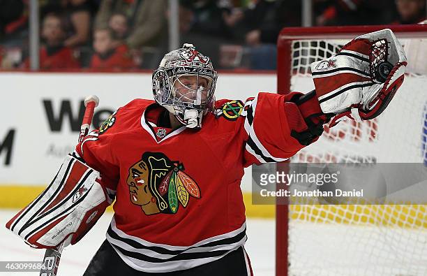 Antti Raanta of the Chicago Blackhawks makes a glove save against the Arizona Coyotes at the United Center on February 9, 2015 in Chicago, Illinois.