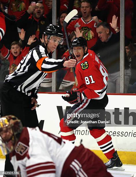 Marian Hossa of the Chicago Blackhawks celebrates his second period goal over Mike Smith of the Arizona Coyotes as referee T.J. Luxmore signals the...