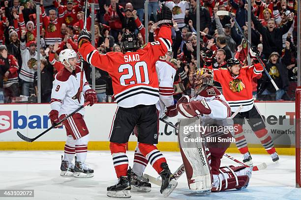 Brandon Saad of the Chicago Blackhawks reacts next to goalie Mike Smith of the Arizona Coyotes as Marian Hossa celebrates in the background, after...
