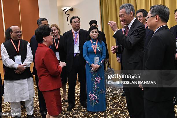 Singapore's Prime Minister Lee Hsien Loong chats with Margaret Chan , director-general of World Health Organisation , and other heads of delegations...