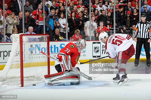 Antoine Vermette of the Arizona Coyotes scores on goalie Antti Raanta of the Chicago Blackhawks in the shoot-out during the NHL game at the United...