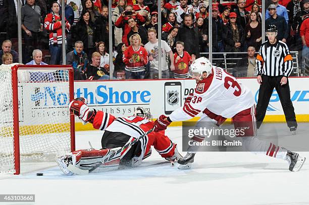 Lucas Lessio of the Arizona Coyotes scores on goalie Antti Raanta of the Chicago Blackhawks in the shoot-out during the NHL game at the United Center...