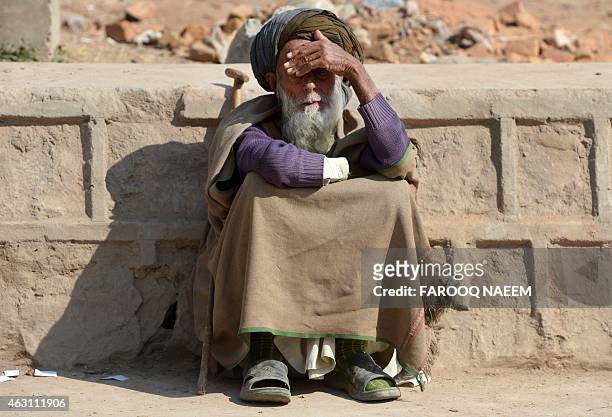 Elderly Afghan refugee Khanzada sits outside the office of the National Database Registration Authority and the United Nations High Commissioner for...