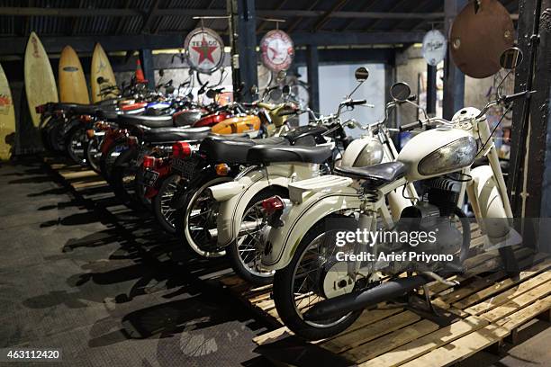 Number of old motorcycle parked as a display in ManShed Cafe, Sanur. The ManShed cafe in Sanur, Bali is themed on an old style garage and is full of...