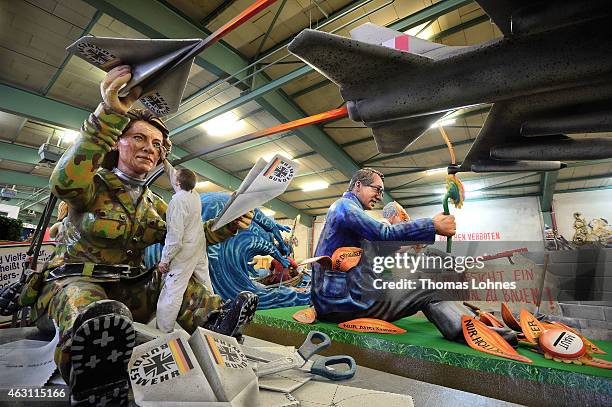 Stefan Wolleck works at the Carnival parade float satirizing the German minister of defence Ursula von der Leyern under the motto 'Ready for...