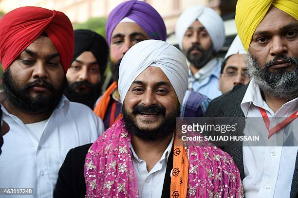 Senior Leader of India's Aam Aadmi Party Jarnail Singh poses with supporters as he arrives for a meeting in New Delhi on February 10, 2015. India's...