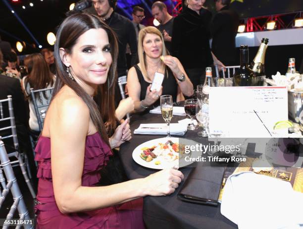 Actress Sandra Bullock with Champagne Nicolas Feuillatte at the 19th Annual Critics' Choice Movie Awards attends Barker Hangar on January 16, 2014 in...