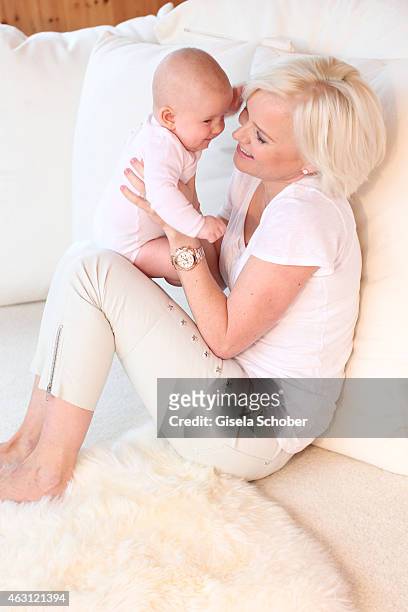 Barbara Sturm poses with her newborn daughter Pepper during a portrait session at Hotel Stanglwirt on January 24, 2015 in Going, Austria.