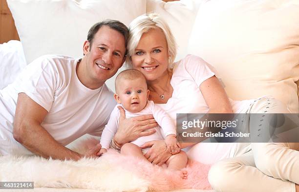 Barbara Sturm and her husband Adam Waldman pose with their newborn daughter Pepper during a portrait session at Hotel Stanglwirt on January 24, 2015...