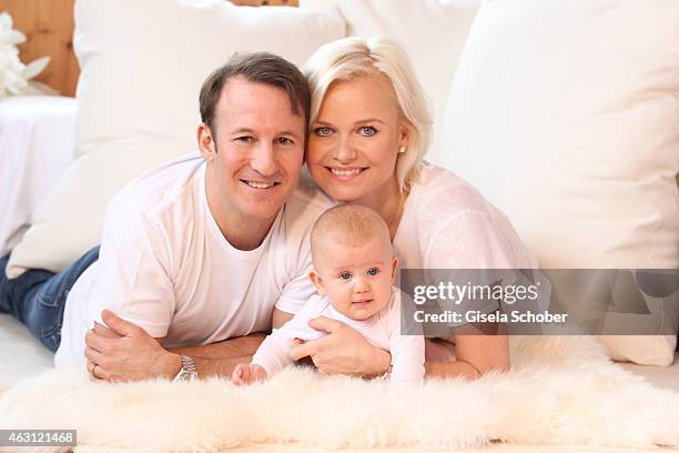 Barbara Sturm and her husband Adam Waldman pose with their newborn daughter Pepper during a portrait session at Hotel Stanglwirt on January 24, 2015...