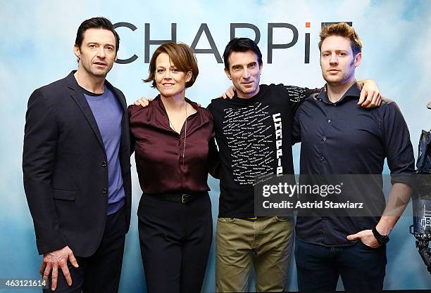 Actors Hugh Jackman, Sigourney Weaver and Sharlto Copley pose with director Neill Blomkamp at the "Chappie" Cast Photo Call at Crosby Street Hotel on...